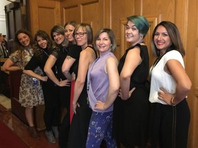 Bhinder Sajan, right to left, Shannon Waters, Liza Yuzda, Justine Hunter, Jen Holmwood, Katie DeRosa, Tanya Fletcher and Kylie Stanton pose for a photo at the B.C. Legislature in Victoria on Thursday, March 28, 2019. A dress code debate at British Columbia's legislature has prompted some women staff and journalists to roll up their sleeves in protest.