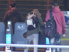 Fare gate evaders entering and exiting through the gates designated handicap at Stadium SkyTrain station.