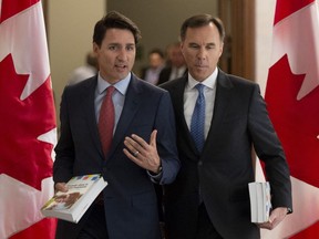 Prime Minister Justin Trudeau and Finance Minister Bill Morneau speak as they walk to the House of Commons in Ottawa on Tuesday.