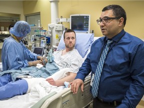 Dr. Aneal Khan, right, a University of Calgary researcher, and patient Josh McQuillin, of Prince George, B.C., who is the first Canadian in history to receive a direct intravenous injection gene replacement therapy, at the University of Calgary's clinical trials unit on Thursday.
