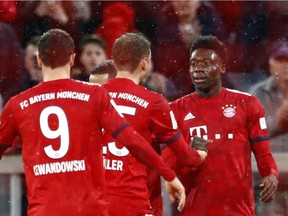 Bayern Munich's Alphonso Davies (right) celebrates after scoring his side's sixth goal in their German Bundesliga match against Mainz in Munich, Germany, on Sunday, March 17, 2019.