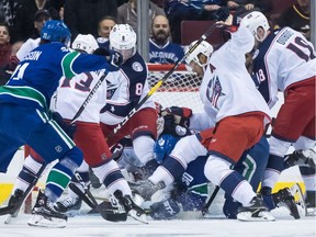 Markus Granlund digs for the puck in front of Columbus Blue Jackets goalie Sergei Bobrovsky.