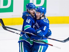 Vancouver Canucks Elias Pettersson, left, and Brock Boeser have slowed down on their goal celebrations of late as playoff-seeking teams have paid extra attention to the young guns defensively.