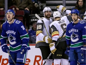 Vegas Golden Knights' Alex Tuch (89) and teammate Colin Miller (6) celebrate a goal during first period NHL hockey action against the Vancouver Canucks, in Vancouver on Saturday, March 9, 2019.