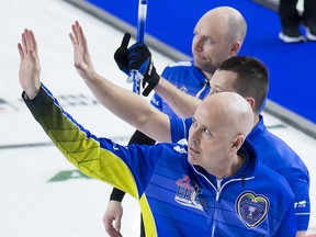 Alberta skip Kevin Koe, lead Ben Hebert and third B.J. Neufeld wave to the crowd after beating Northern Ontario in the Page Playoff 1 vs 2 draw at the Brier in Brandon, Man., Saturday, March 9, 2019. (THE CANADIAN PRESS/Jonathan Hayward)