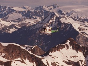 A spokesman with a heli-skiing outfit in eastern B.C. says a chartered helicopter with 12 people aboard made a bad landing and rolled on Thursday, but there were no injuries. A file photo of a heli-ski flight near Blue River, B.C. is shown here.