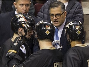 Vancouver Warriors head coach Chris Gill talks with his players during a timeout.