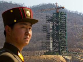 A soldier stands in front of the Unha-3 rocket at a launching site in Tongchang-ri, North Korea, in April 2012.