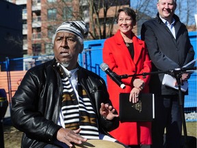 Albert Briggs plays drums as Melanie Mark, Minister of Advanced Education, Skills and Training and MLA for Vancouver-Mount Pleasant; and Kennedy Stewart, Mayor of Vancouver look on at the opening of Norah Hendrix Place.