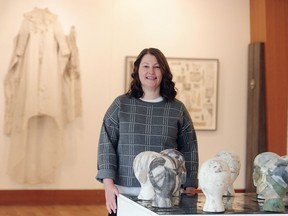 Artist Tracy McNenemy with her work in an exhibition at the Maritime Museum in Vancouver.