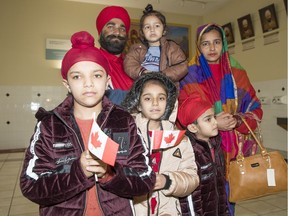 Husband Shamsheer Singh Khalsa, back left, and wife Havinder Kaur Khalsa, back right. Their children, from left, Tirath, 11, Jasmeet, 8, and Zorawer, 6. Fathe, 3, is in his father's arms. The Surrey Sikh community sponsored this Afghan-Sikh refugee family.