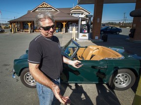 Ian Clarke gases up his 1962 Triumph TR4 at the Campbell River gas station in South Surrey on March 19.
