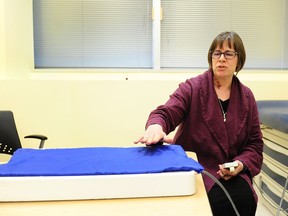 UBC researcher Liisa Holsti, with a therapeutic robot that simulates human skin-to-skin contact and helps to reduce pain for babies, in the neonatal intensive-care unit at B.C. Women’s Hospital in Vancouver on March 22.