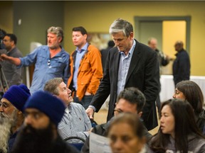 B.C. Liberal leader Andrew Wilkinson talks to farmers in Surry on Sunday at a rally to protest plans to change laws around the Agricultural Land Reserve that would ban farmers from applying to have their farms or part of their farms removed from the ALR.