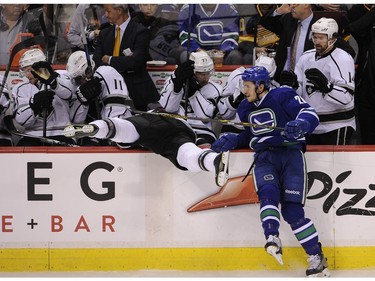 Vancouver Canucks Frank Corrado 26, knocks  the Los Angeles Kings Robyn Regehr   44 into the bench, in Rogers Arena in Vancouver on March 12, 2015. Mark van Manen /PNG Staff  Photographer   see   Brad Ziemer /Vancouver Sun /Province Sports  [PNG Merlin Archive]