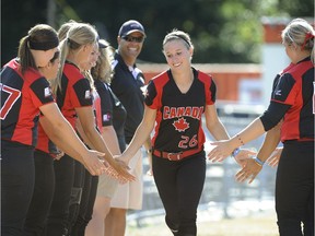 Larissa Franklin, centre, is welcomed on the field by her teammates during the 2014 Canadian Open Fastpitch Tournament at Softball City in Surrey.