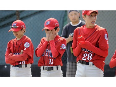 Dejected Hastings Little league players shows their pain after losing 8-0 to  Little Mountain in the  B.C. Little League Championships tournament in New Westminster's Moody Park, on August 1, 2010.