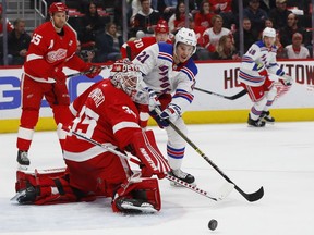 Rookie Brett Howden of the New York Rangers pursues a loose puck in front of Detroit Red Wings' goaltender Jimmy Howard during NHL action on March 7 in Detroit.