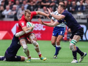 Canada's Harry Jones is tackled by Scotland's Gavin Lowe during World Rugby Sevens Series action in Vancouver on Sunday, March 10, 2019.