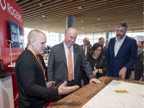Premier John Horgan (second from left), Minister of Citizen's Services Jinny Sims (third left) and Rogers Chief Technology Officer Jorge Fernandes (far right) get a demonstration on how 5G will enhance smart city planning at the B.C. Tech Summit in Vancouver on Tuesday.