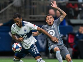 Vancouver Whitecaps' Derek Cornelius (13) plays the ball against Minnesota United's Miguel Ibarra (10) during the first half MLS soccer action in Vancouver on Saturday, March 2, 2019.