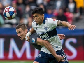Vancouver Whitecaps striker Fredy Montero (right) vies for the ball with Minnesota United's Jan Gregus during their March 2, 2019 MLS game at B.C. Place Stadium.