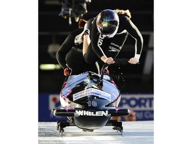 WHISTLER, BRITISH COLUMBIA FEB. 6, 2009. U.S.A.'s Erin Pac and  Michelle Rzepka jump into their sled with the course reflecting in Pac helmet  at World Cup Bobsleigh  at the Whistler, to their 3rd palce finish at the Whistler Sliding Centre in Whistler. For Ian Walker Sports story. Mark van Manen/Vancouver Sun. [PNG Merlin Archive]