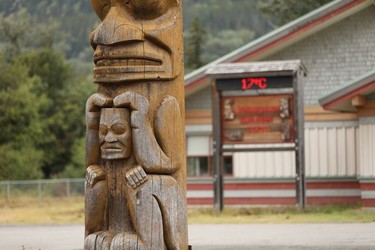 Part of a 20-metre totem pole is seen at the elementary school in Gitwinksihlkw (Canyon City) in northwestern British Columbia on Saturday, Sept. 1, 2018. The pole represents elders teaching the children, with a supernatural bird at top that is said to have stopped the deadly flow of the Tseax volcano around 1780.