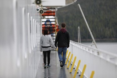 A couple strolls aboard the B.C. Ferries "Northern Expedition" as it sails the Inside Passage from Port Hardy on Vancouver Island to Prince Rupert, B.C., on Thursday Aug. 30, 2018. The 16-hour cruise affords spectacular views.