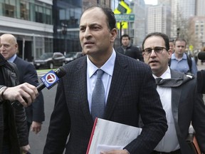 David Sidoo leaves following his federal court hearing Friday, March 15, 2019, in Boston. Sidoo pleaded not guilty to charges as part of a wide-ranging college admissions bribery scandal. (Jonathan Wiggs/The Boston Globe via AP) ORG XMIT: CPT601