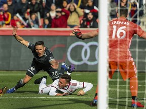 Vancouver Whitecaps defender Jake Nerwinski (28) knocks Real Salt Lake forward Corey Baird (17) to the ground and gets called for the foul inside the box, giving Real Salt Lake a penalty kick which they converted during an MLS soccer match in Sandy, Utah, Saturday, March 9, 2019.