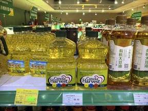 Bottles of Canola Harvest brand canola oil, manufactured by Canadian agribusiness firm Richardson International, are seen on the shelf of a grocery store in Beijing, Wednesday, March 6, 2019. One of Canada's largest grain processors said Tuesday that China has revoked its permit to export canola there, a move that some saw as retaliation for the Canadian government's arrest of a top executive for the Chinese tech giant Huawei.
