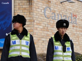 Police officers stand guard outside the Canadian embassy in Beijing on January 27, 2019.