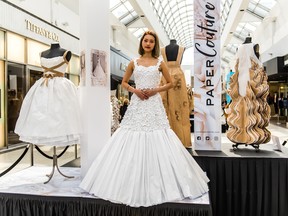 A model wears a gown created by Langara College student Siqi Zhong as part of the Paper Couture Exhibition at Oakridge Centre.