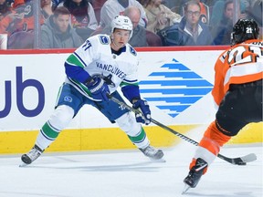Nikolay Goldobin of the Vancouver Canucks looks to move the puck against the Philadelphia Flyers during a February 2019 NHL game in Philadelphia.