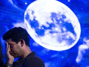 TEL AVIV, ISRAEL - APRIL 11: An Israeli man react after Beresheet spacecraft fails to land safely on the moon on April 11, 2019 in Tel Aviv, Israel. The Israeli spacecraft - called Beresheet, which is a joint project between SpaceIL, a privately funded Israeli non-profit organisation, and Israel Aerospace Industries failed to land on the lunar surface after the apparent failure of its main engine.