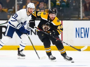 Matt Grzelcyk of the Boston Bruins break away from checker William Nylander of the Toronto Maple Leafs during Thursday's NHL playoff action at the TD Garden in Boston, Mass.