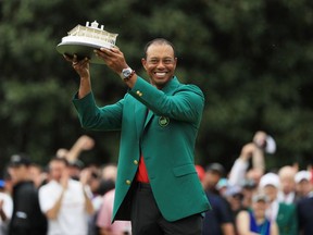 Tiger Woods celebrates with the Masters trophy during the green jacket ceremony after winning the Masters at Augusta National Golf Club on April 14, 2019 in Augusta, Ga.