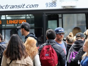 Riders board a transit bus on Douglas Street. Victoria council recently decided to start charging for downtown parking on Sundays to pay for free bus passes for children and youth.