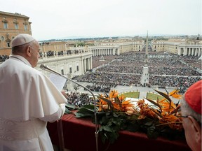 Pope Francis delivers the "Urbi et Orbi" blessing to the city and to the world from the balcony of St Peter's basilica after the Easter Sunday Mass in the Vatican.