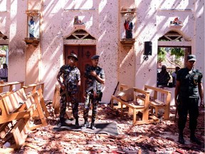 Sri Lankan soldiers look on inside the St Sebastian's Church at Katuwapitiya in Negombo on Sunday, April 21, 2019, following a bomb blast during the Easter service that killed tens of people.