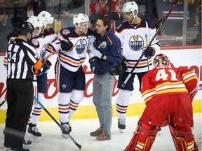 Edmonton Oilers Connor McDavid after colliding with Mike Smith of the Calgary Flames during NHL hockey at the Scotiabank Saddledome in Calgary on Saturday, April 6, 2019.