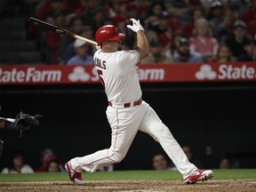 Los Angeles Angels' Albert Pujols follows through on an RBI single during the third inning of the team's baseball game against the Seattle Mariners, Thursday, April 18, 2019, in Anaheim, Calif.