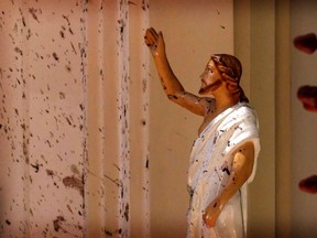 Blood stains are seen on the wall and on a Jesus Christ statue at the St. Sebastian's Church after blast in Negombo, north of Colombo, Sri Lanka, on Easter Sunday, April 21, 2019. More than 200 people were killed and hundreds more injured in eight blasts that rocked churches and hotels in and just outside Sri Lanka's capital.