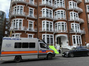 A police van parks outside the Ecuadorian Embassy in London, after WikiLeaks founder Julian Assange was arrested by officers from the Metropolitan Police and taken into custody Thursday April 11, 2019.
