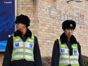 Police officers stand guard outside the Canadian embassy in Beijing on January 27, 2019.
