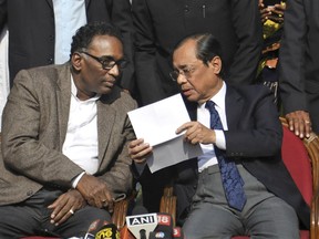FILE - In this Jan. 12, 2018 file photo, Indian Supreme Court judge Justice Ranjan Gogoi, right, speaks with Justice Jasti Chelameswar as they address the media in New Delhi, India. A former employee of India's Supreme Court has accused Gogoi, now the country's chief justice, of sexual harassment, an accusation that was vehemently denied by the judge, reports said Saturday, April 20, 2019. (AP Photo/File)