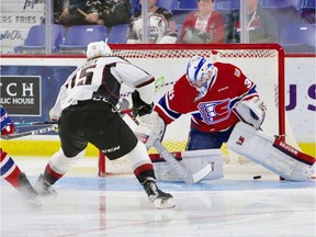 Vancouver Giants' Owen Hardy gets the puck past Spokane Chiefs goalie Bailey Brkin in Game 1 of their WHL playoff series. [PNG Merlin Archive]