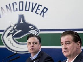 Vancouver Canucks general manager Jim Benning (right) and head coach Travis Green pause for a moment during a news conference at Rogers Arena in Vancouver on Monday, April 8, 2019. The Canucks finished their season this past weekend failing to make the 2019 playoffs.