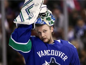 Vancouver Canucks goaltender Thatcher Demko adjusts his mask during second period of an NHL game against the Vegas Golden Knights, in Vancouver on March 9, 2019.